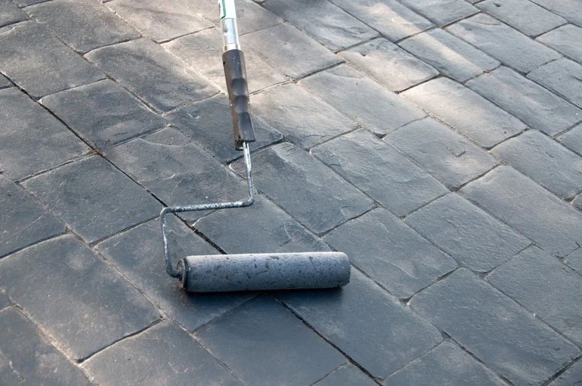 Concrete sealing service in Millington TN - applying sealant with roller on concrete pavers